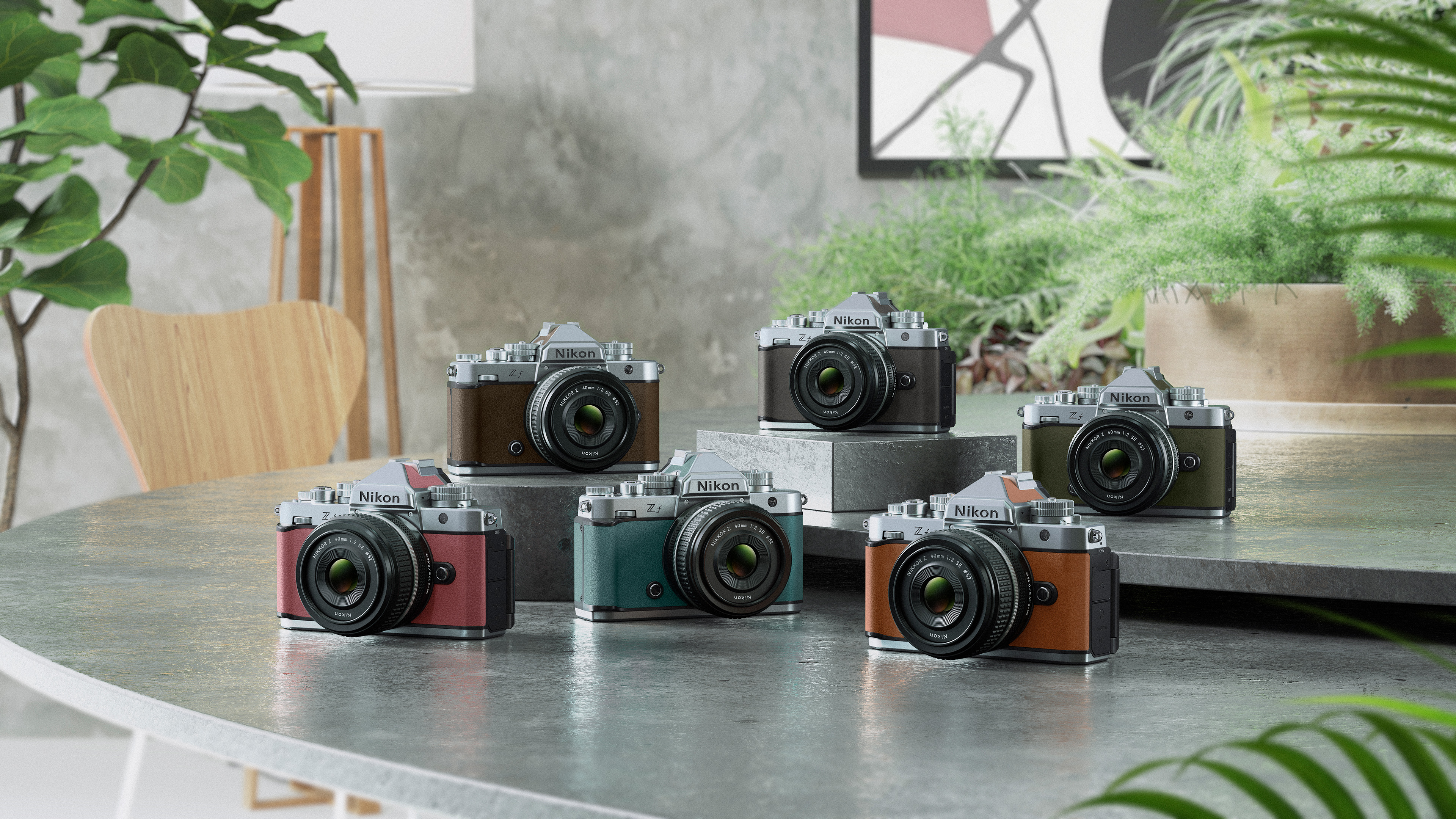 six_different_colors_of_the_nikon_z_f_are_placed_on_a_round_table_surrounded_by_plants_and_art.jpeg