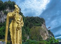 Lord Murugan Gold Statue against the sky.jpg